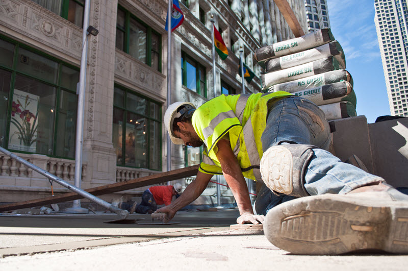 Construction worker laying concrete