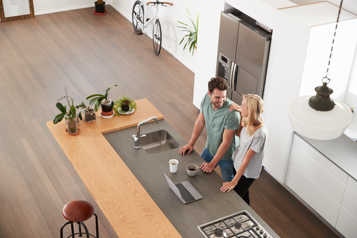 Millennial couple standing in their modern kitchen