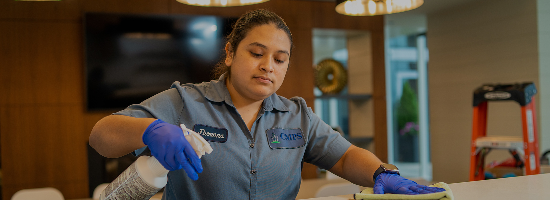 Janitorial staff cleans lobby desk