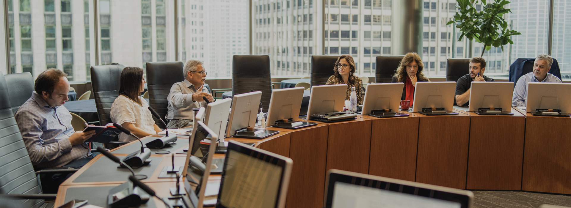 Several GNP Realty staff members have a meeting in a large boardroom