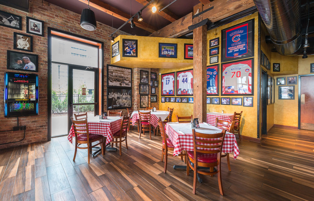 Large seating area at Pizano's Restaurant with sports memorabilia on the walls